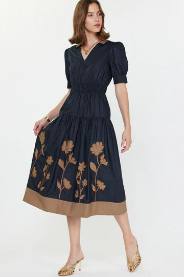 short sleeved navy blue dress with brown floral appliques on the skirt