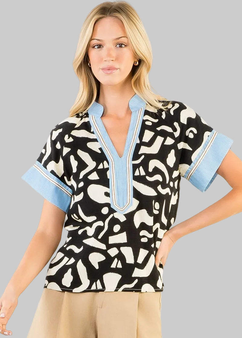 black and white patterned top with blue accents