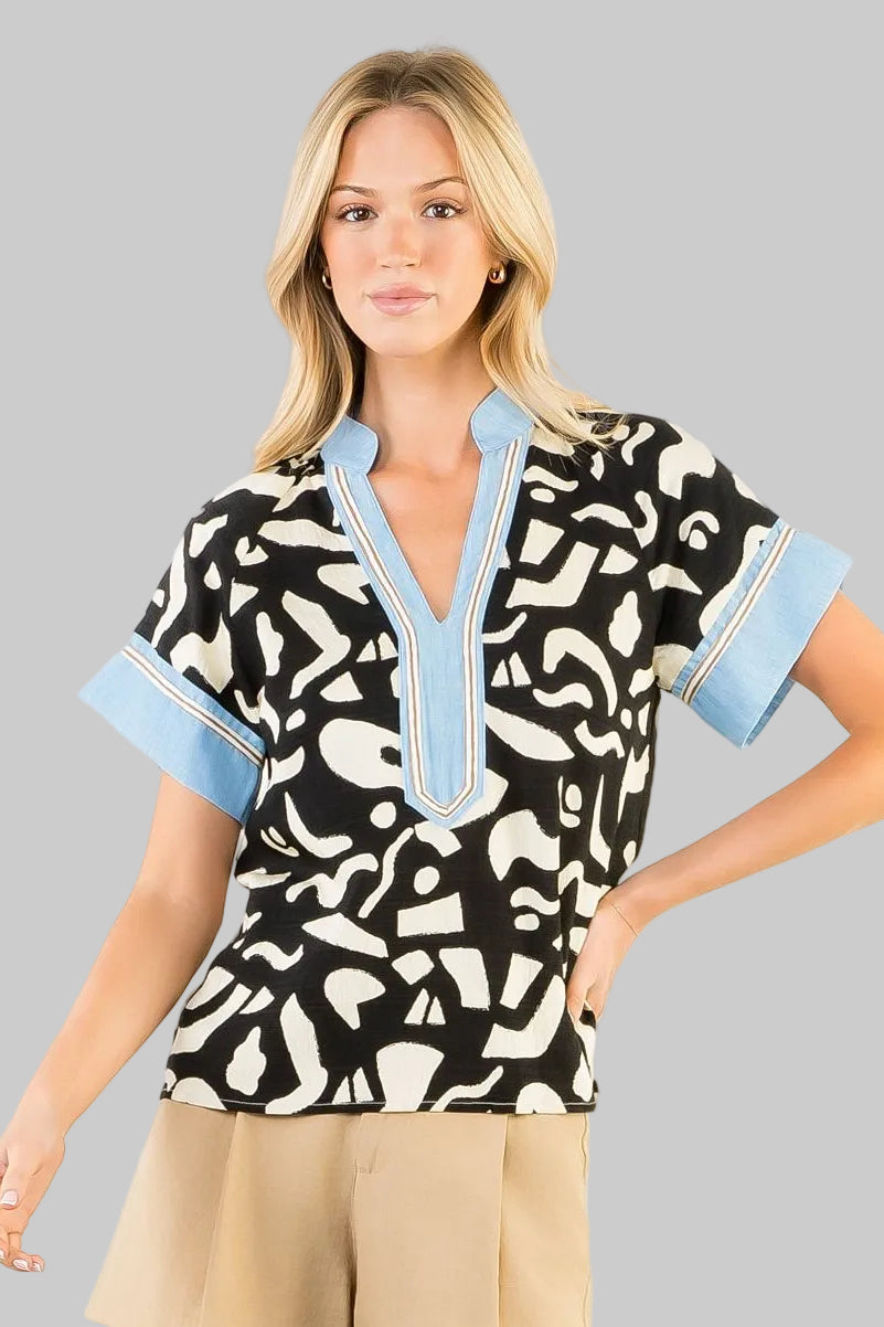 black and white patterned top with blue accents