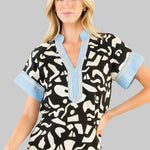 black and white patterned top with blue accents