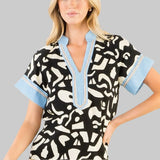 black and white patterned top with blue accents