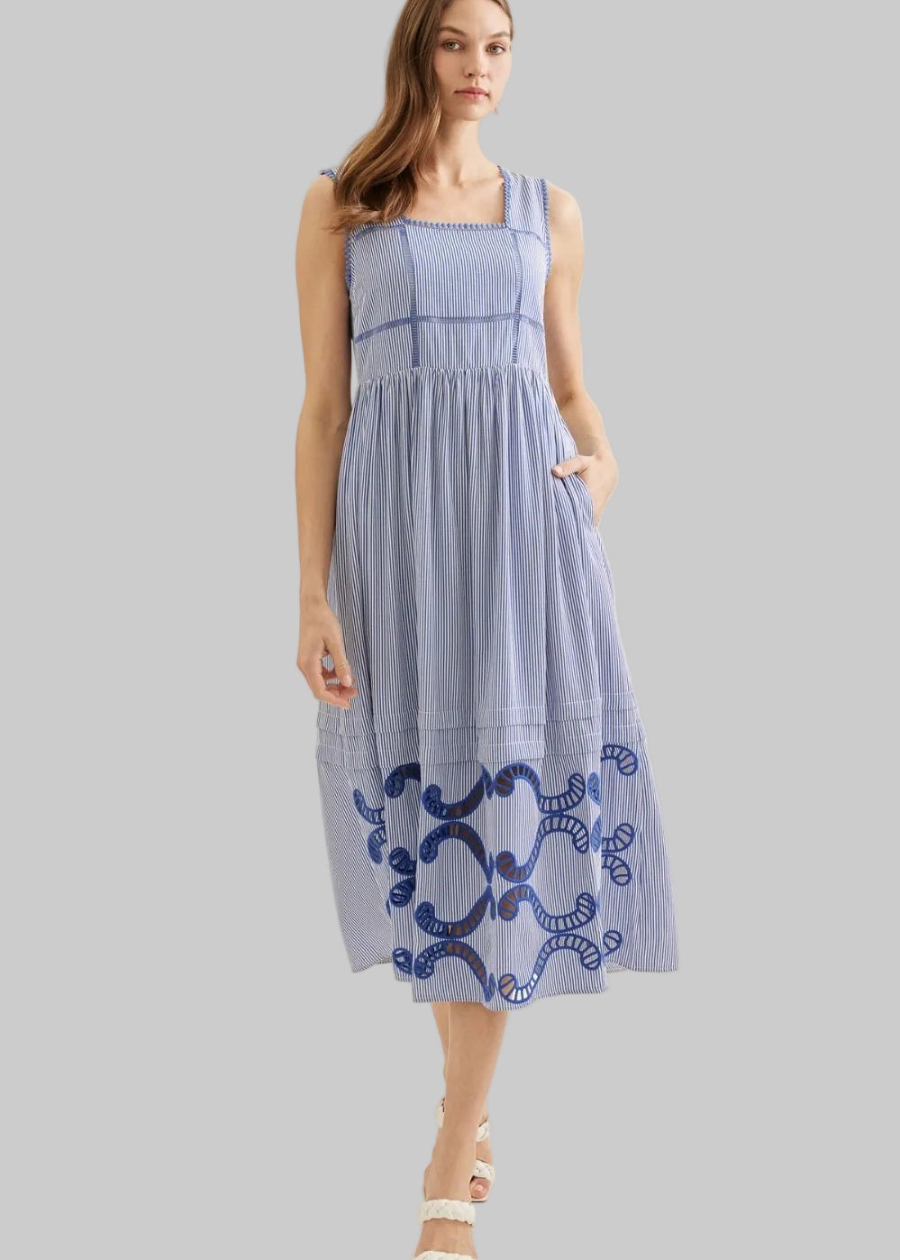 Woman wearing a blue dress with embroidery 