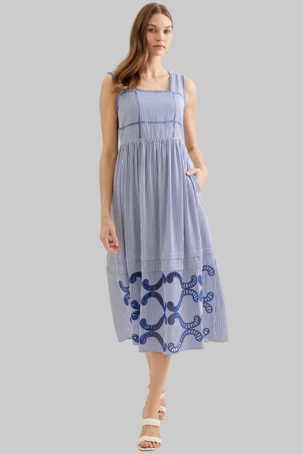 Woman wearing a blue dress with embroidery 