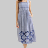 Woman wearing a blue dress with embroidery 