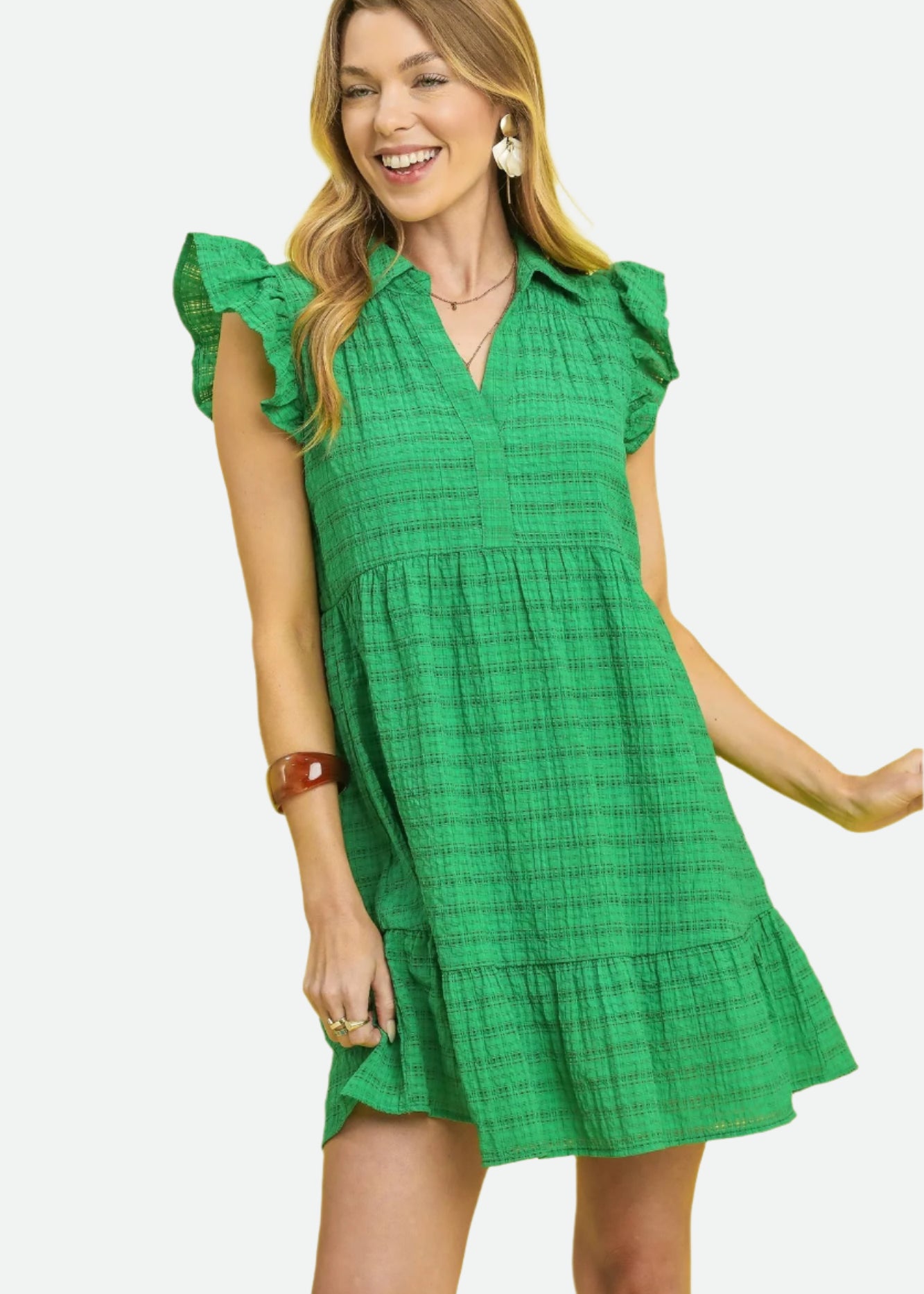 Woman wearing a green dress against a yellow background