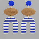 Earrings with blue and white striped 'U' shapes and brown football-shaped pendants