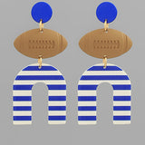 Earrings with blue and white striped 'U' shapes and brown football-shaped pendants