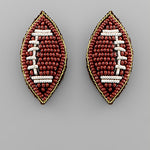 Beaded football-shaped earrings on a 