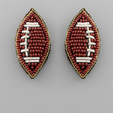 Beaded football-shaped earrings on a 