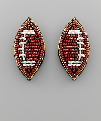 Beaded football-shaped earrings on a 