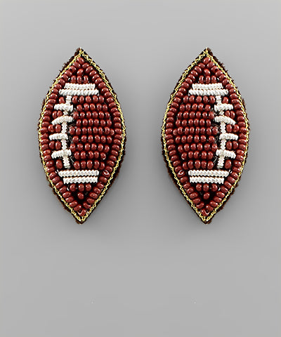Beaded football-shaped earrings on a 