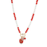 Necklace with red and white beads and a football charm on a white background