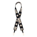 A black fabric shoulder strap with GAME DAY beige text and star patterns, featuring gold-tone metal clips at the bottom.
