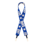 A blue purse strap with white text reading 'DAY GAME DAY' and white star patterns, featuring gold-tone metal clasps at the bottom.