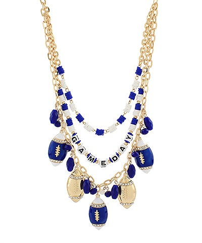 A gold-tone statement necklace featuring a multi-strand beaded design with blue and white beads, football-shaped charms, and a central beaded word charm spelling 'FAMILY DAY'.