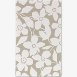 A hand towel with a floral pattern in tan and white colors.