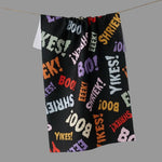 A black towel. The fabric is covered in colorful repeated text including BOO, YIKES!, EEEK!, SHRIEKS!, and LIZAH.
