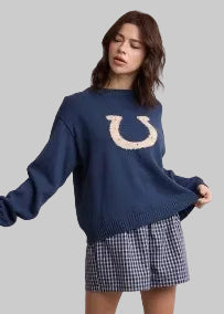  a navy blue crewneck sweater with a large horseshoe graphic on the chest