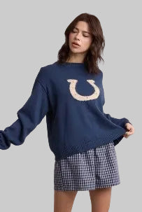  a navy blue crewneck sweater with a large horseshoe graphic on the chest