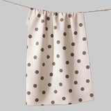 White towel with brown polka dots