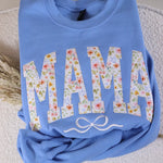 Light Blue sweatshirt with floral lettering spelling MAMA