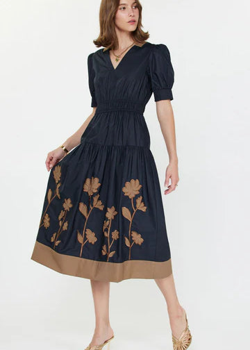 short sleeved navy blue dress with brown floral appliques on the skirt 