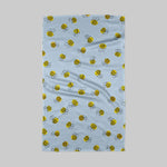 Towel with bee pattern on a light blue background