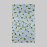 Towel with bee pattern on a light blue background
