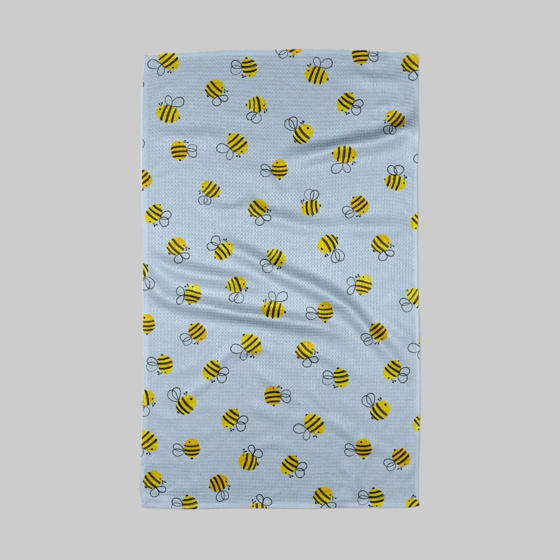 Towel with bee pattern on a light blue background