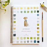Watercolor workbook titled 'Animals' with a dog illustration