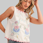 White sleeveless top with floral embroidery