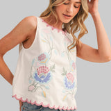 White sleeveless top with floral embroidery
