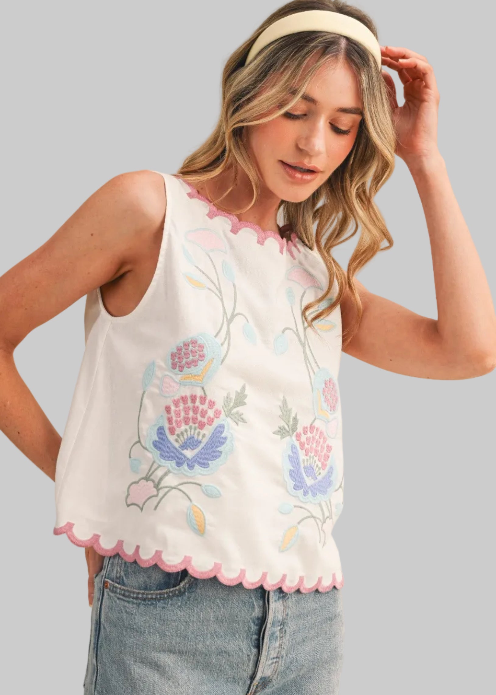 White sleeveless top with floral embroidery