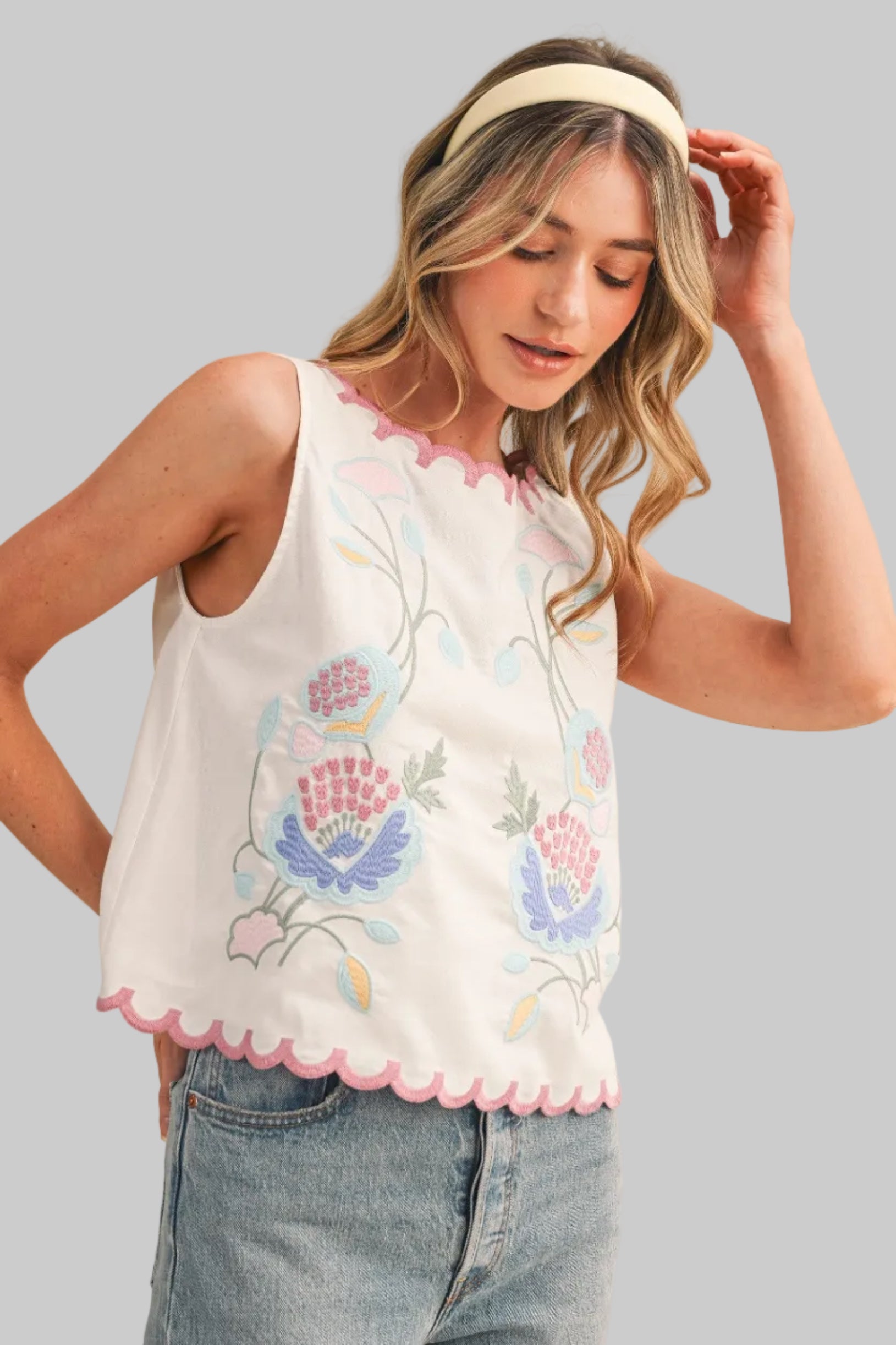 White sleeveless top with floral embroidery