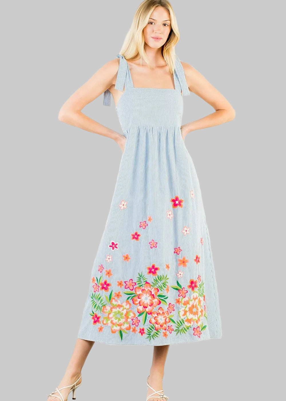 light blue stripe dress with floral embroidery on the hem