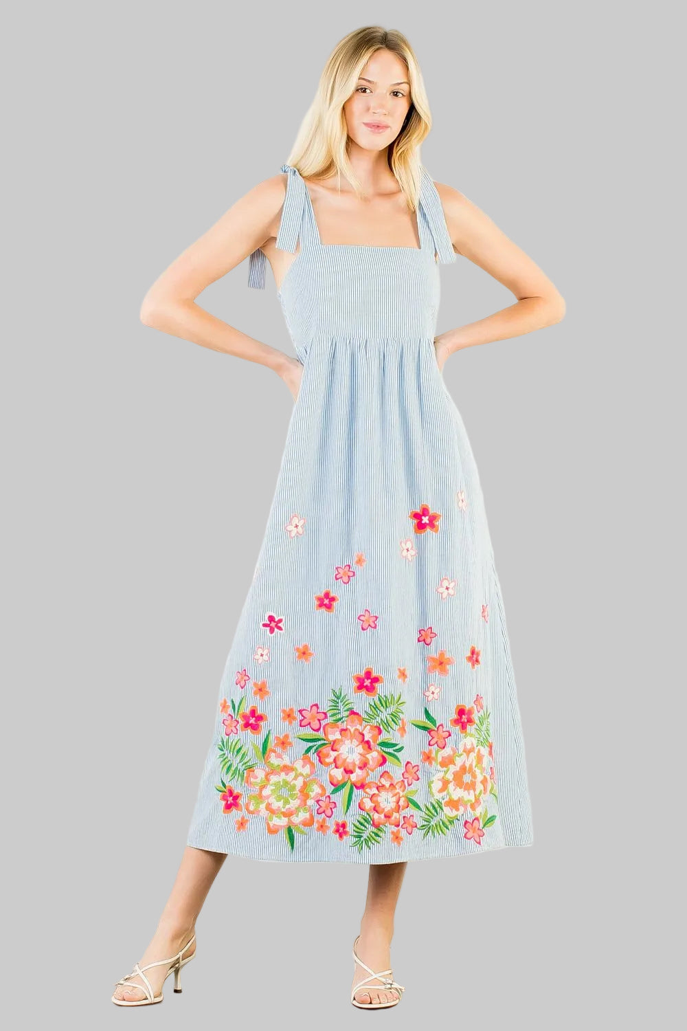 light blue stripe dress with floral embroidery on the hem