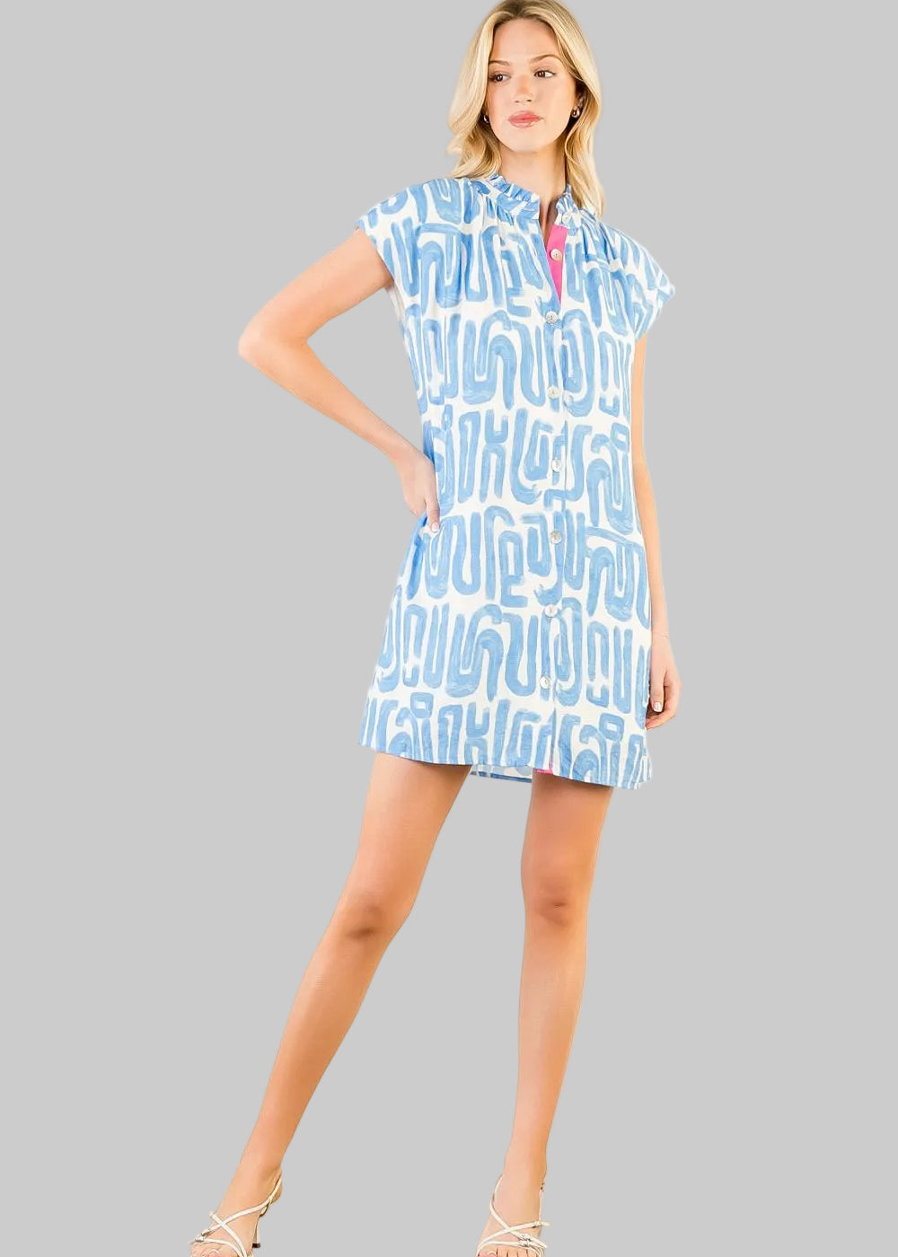 short-sleeve mini dress with a light blue and white abstract pattern, featuring a pink collar detail