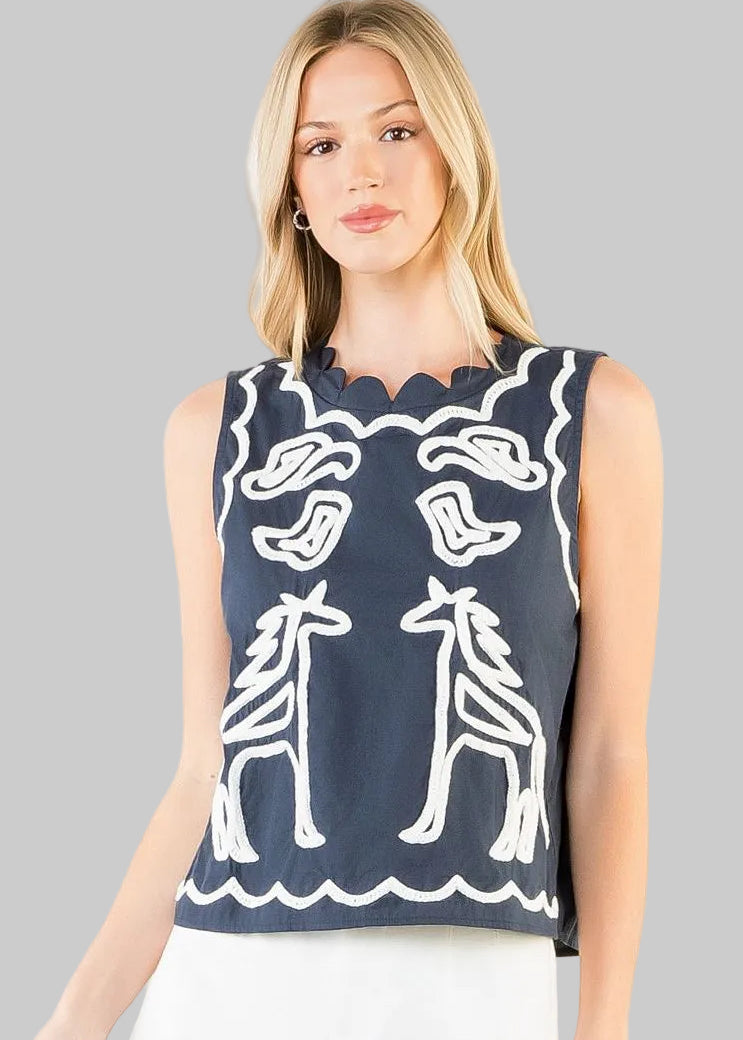 sleeveless navy top with white embroidery