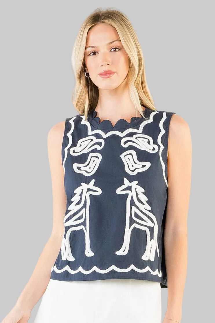 sleeveless navy top with white embroidery